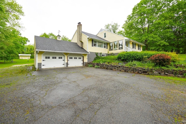 136 Foggintown Rd, Brewster, NY 10509 - view of front of house with a chimney and asphalt driveway
