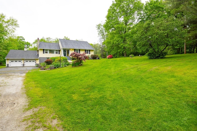136 Foggintown Rd, Brewster, NY 10509 - view of front of house featuring dirt driveway, a front lawn, a chimney, and an attached garage