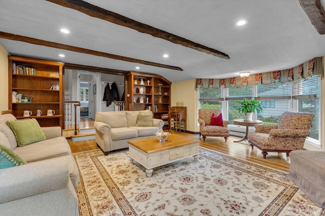 living area with wood finished floors, beam ceiling, recessed lighting, built in features, and baseboards