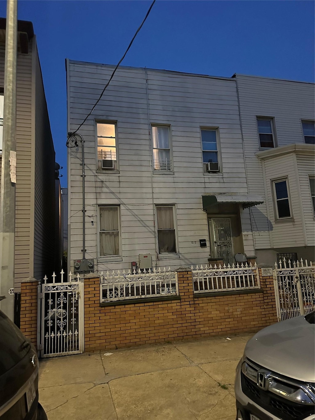 51-17 34th St, Long Island City, NY 11101 - view of front of house with a gate and cooling unit
