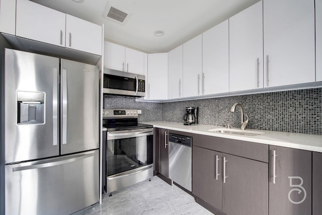 31-10 28th Rd Unit 1A, Astoria, NY 11102 - kitchen with appliances with stainless steel finishes, a sink, light countertops, and white cabinetry
