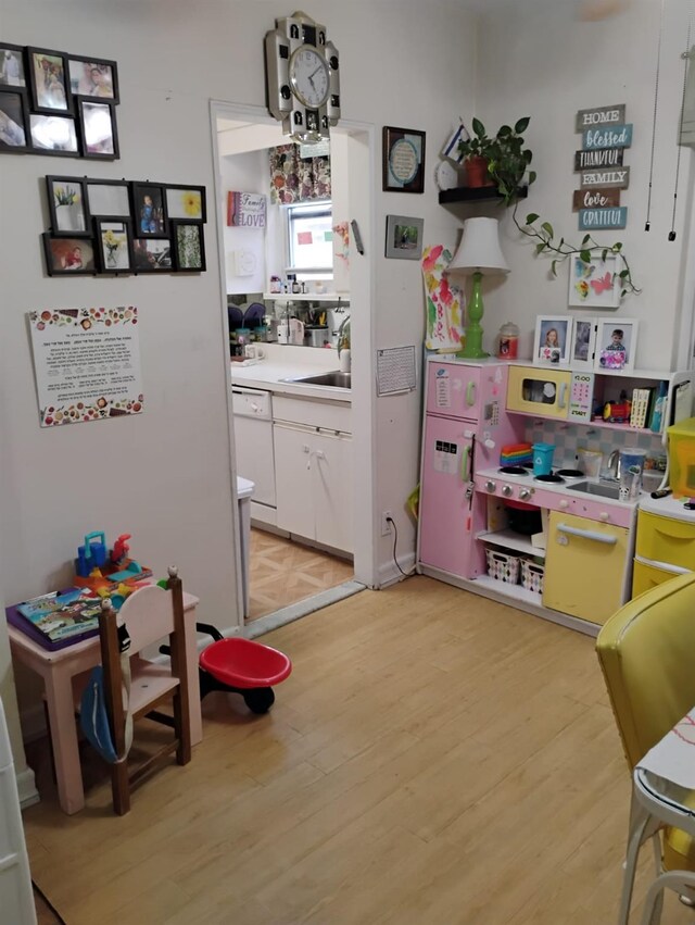284 Central Ave Unit D-6, Lawrence, NY 11559 - game room with light wood-style floors and a sink