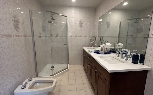 full bath featuring tile walls, a stall shower, tile patterned flooring, and vanity