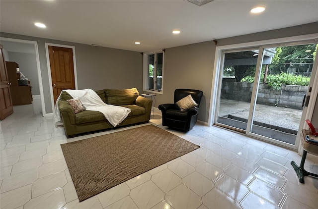 living room with recessed lighting, baseboards, and light tile patterned floors