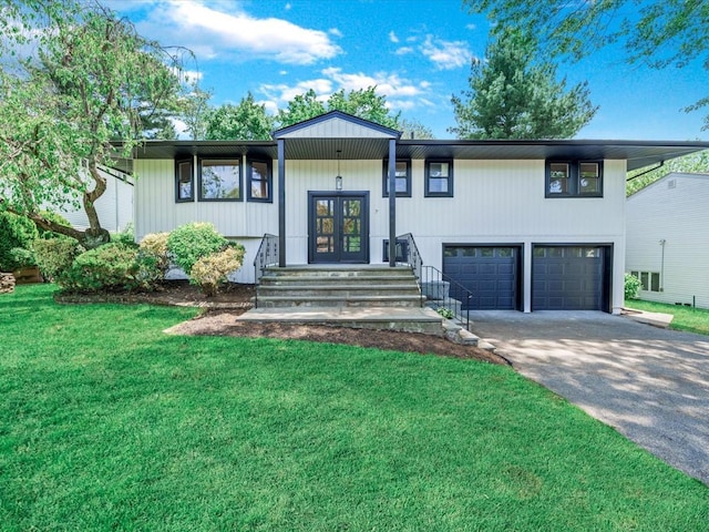 7 Pal Way, Plainview, NY 11803 - bi-level home featuring french doors, an attached garage, a front yard, and driveway