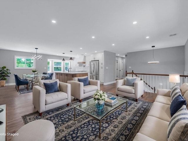 7 Pal Way, Plainview, NY 11803 - living room with a chandelier, wood finished floors, recessed lighting, and baseboards