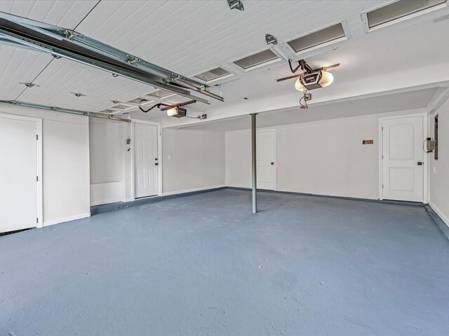 7 Pal Way, Plainview, NY 11803 - garage with a garage door opener and baseboards