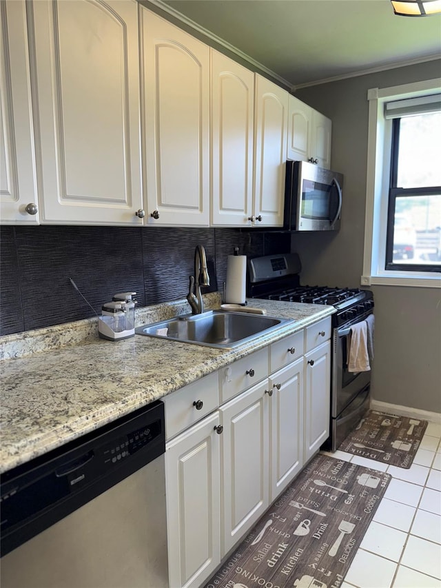 320 Richbell Rd Unit A4, Mamaroneck, NY 10543 - kitchen with stainless steel appliances, a sink, decorative backsplash, white cabinets, and tile patterned flooring