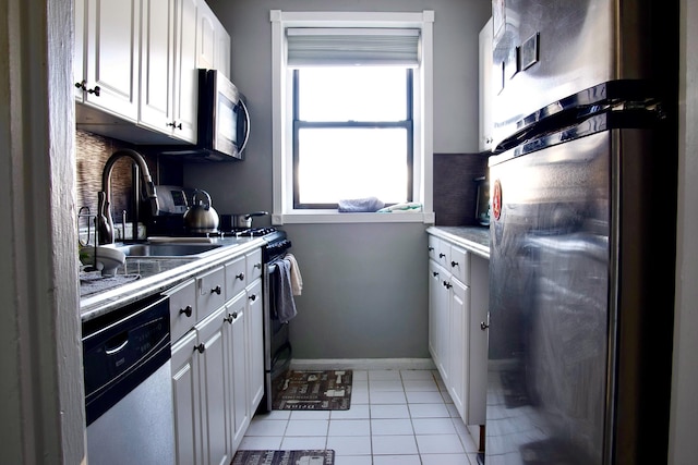 320 Richbell Rd Unit A4, Mamaroneck, NY 10543 - kitchen with stainless steel appliances, a sink, white cabinetry, light tile patterned flooring, and light countertops