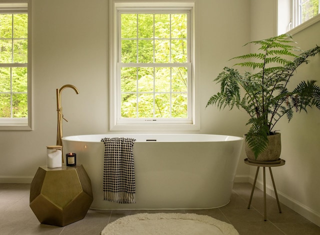 89 Stillerberg Strada, Kerhonkson, NY 12446 - bathroom featuring baseboards, tile patterned flooring, and a freestanding tub
