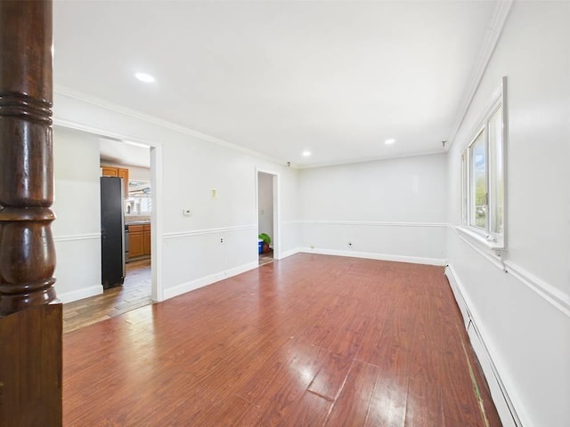 95 State Ave, Wyandanch, NY 11798 - unfurnished room featuring a baseboard heating unit, wood finished floors, ornamental molding, recessed lighting, and baseboards
