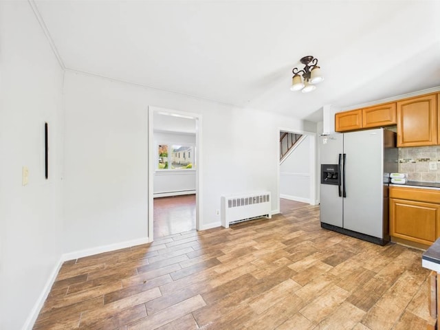 95 State Ave, Wyandanch, NY 11798 - kitchen featuring stainless steel fridge, radiator heating unit, light wood-style flooring, tasteful backsplash, and a baseboard heating unit
