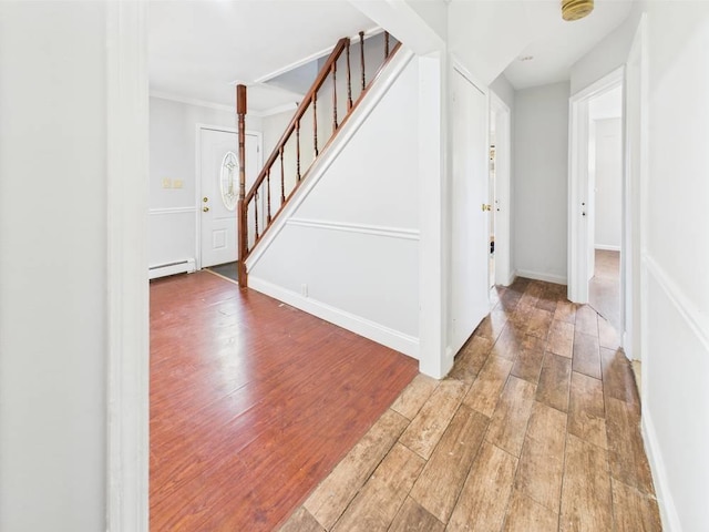 95 State Ave, Wyandanch, NY 11798 - entryway with a baseboard radiator, light wood-style flooring, stairs, and crown molding