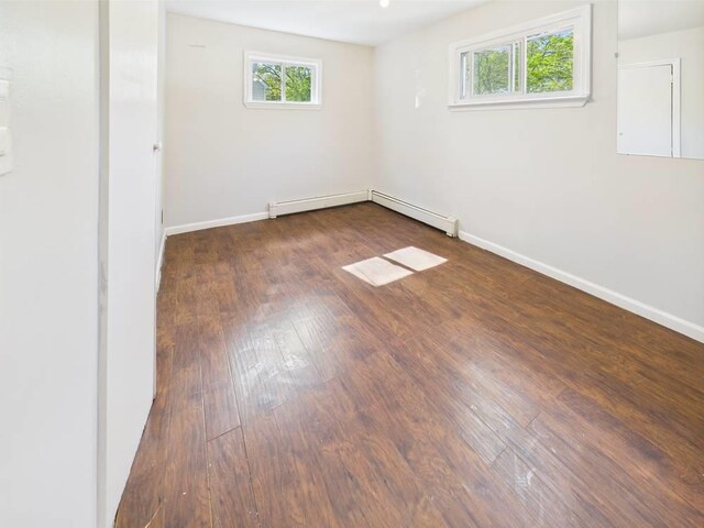 95 State Ave, Wyandanch, NY 11798 - spare room with plenty of natural light, baseboard heating, wood-type flooring, and baseboards