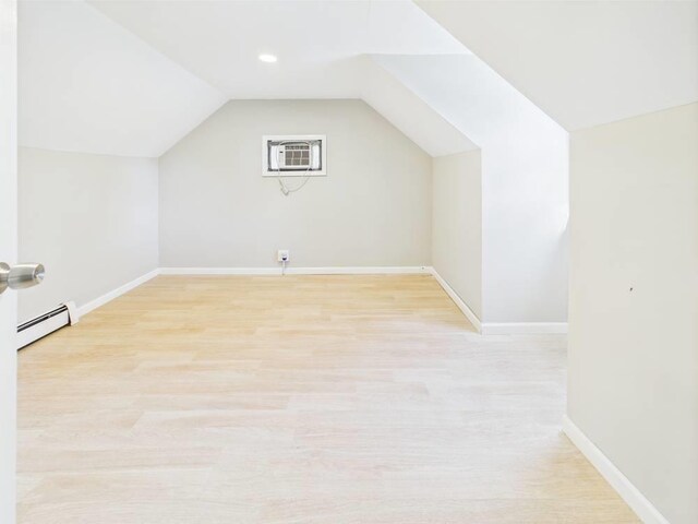95 State Ave, Wyandanch, NY 11798 - bonus room with a baseboard radiator, lofted ceiling, baseboards, light wood-type flooring, and a wall mounted AC