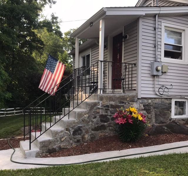 view of property exterior featuring stairway and fence