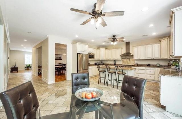 dining space featuring stone tile floors, recessed lighting, a ceiling fan, and baseboards
