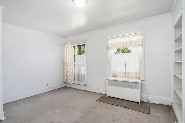 carpeted spare room with ornamental molding, baseboards, and radiator