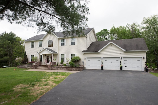 16 Kukas Rd, Monticello, NY 12701 - colonial inspired home with a garage, asphalt driveway, and a front lawn