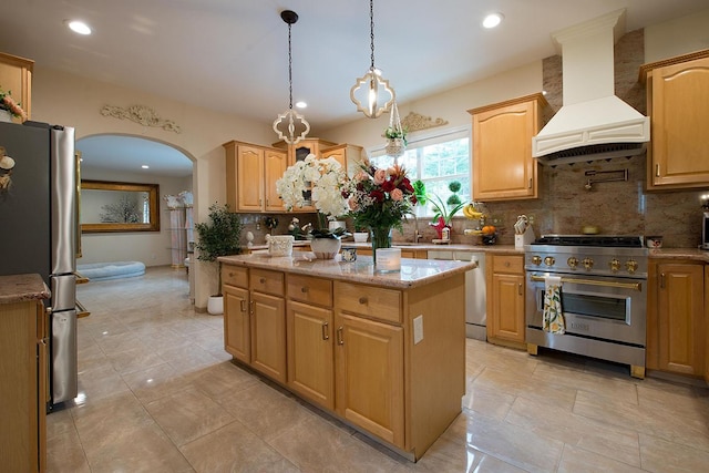16 Kukas Rd, Monticello, NY 12701 - kitchen featuring appliances with stainless steel finishes, custom range hood, arched walkways, tasteful backsplash, and a kitchen island