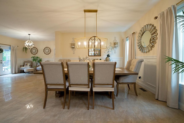 16 Kukas Rd, Monticello, NY 12701 - dining space with a chandelier, a decorative wall, and a wainscoted wall