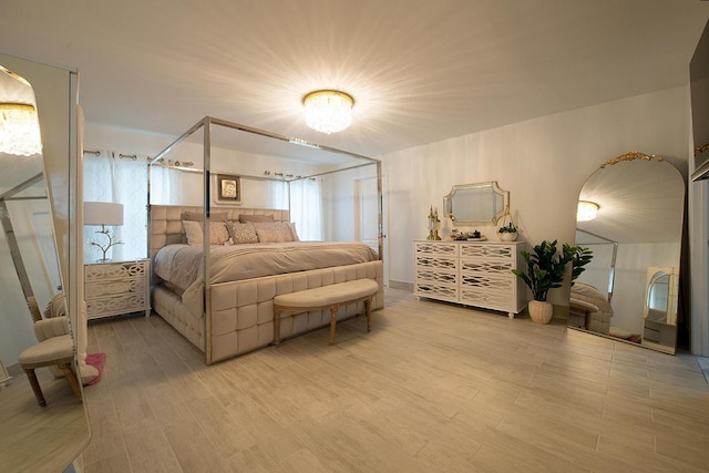 16 Kukas Rd, Monticello, NY 12701 - bedroom with light wood-style floors, multiple windows, and a chandelier