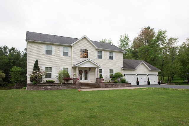 16 Kukas Rd, Monticello, NY 12701 - colonial-style house featuring french doors, an attached garage, asphalt driveway, and a front lawn