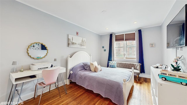 bedroom featuring wood finished floors, baseboards, and recessed lighting