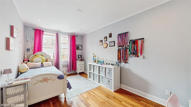 bedroom with baseboards and wood finished floors