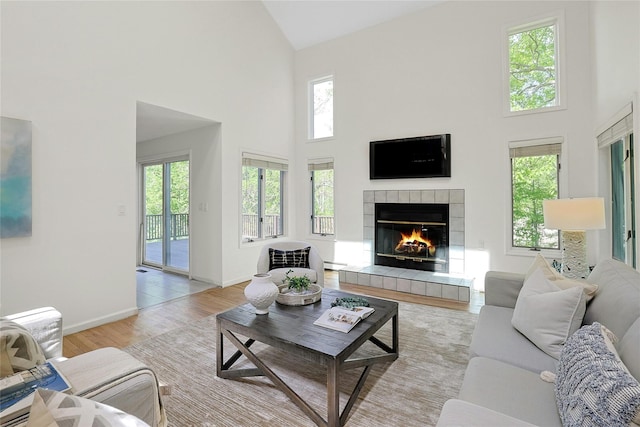 14 Cross Rd, Cortlandt Manor, NY 10567 - living area featuring high vaulted ceiling, a fireplace, plenty of natural light, and baseboards