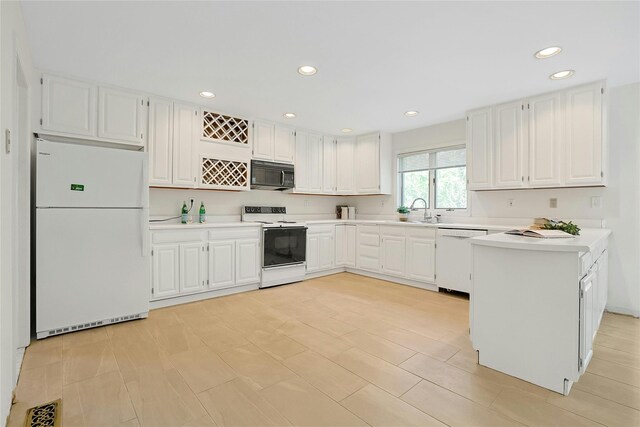 14 Cross Rd, Cortlandt Manor, NY 10567 - kitchen featuring white appliances, light countertops, a peninsula, recessed lighting, and white cabinets