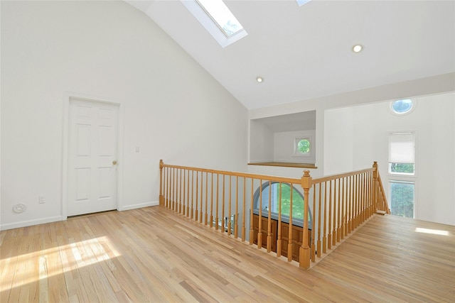 14 Cross Rd, Cortlandt Manor, NY 10567 - hall with a skylight, wood finished floors, high vaulted ceiling, baseboards, and an upstairs landing