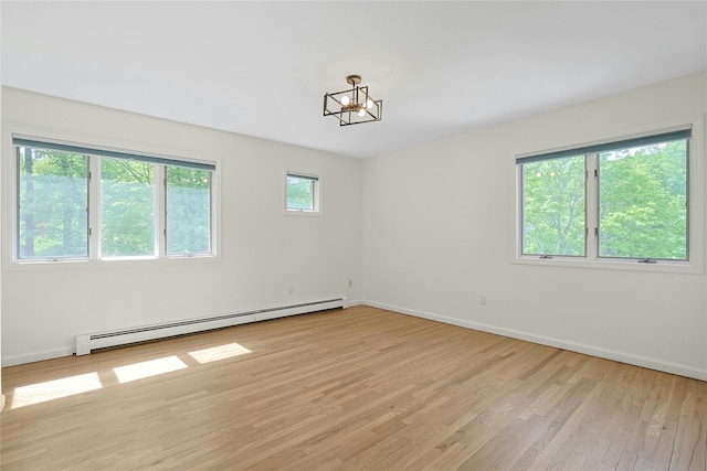 14 Cross Rd, Cortlandt Manor, NY 10567 - unfurnished room featuring a baseboard radiator, light wood-style flooring, baseboards, and a chandelier