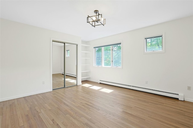 14 Cross Rd, Cortlandt Manor, NY 10567 - unfurnished bedroom featuring a baseboard heating unit, light wood finished floors, a closet, and baseboards