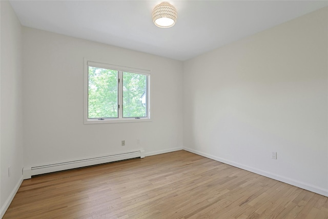 14 Cross Rd, Cortlandt Manor, NY 10567 - empty room with a baseboard heating unit, light wood-type flooring, and baseboards