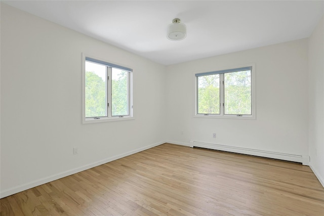 14 Cross Rd, Cortlandt Manor, NY 10567 - spare room with a baseboard radiator, healthy amount of natural light, light wood-style floors, and baseboards