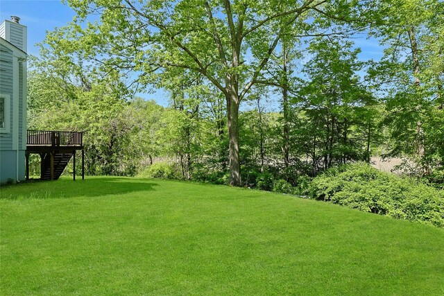 14 Cross Rd, Cortlandt Manor, NY 10567 - view of grassy yard with stairway, a deck, and view of wooded area