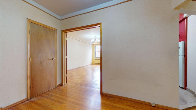 3250 Coney Island Ave Unit E15, Brooklyn, NY 11235 - corridor featuring ornamental molding, a chandelier, light wood-type flooring, and baseboards