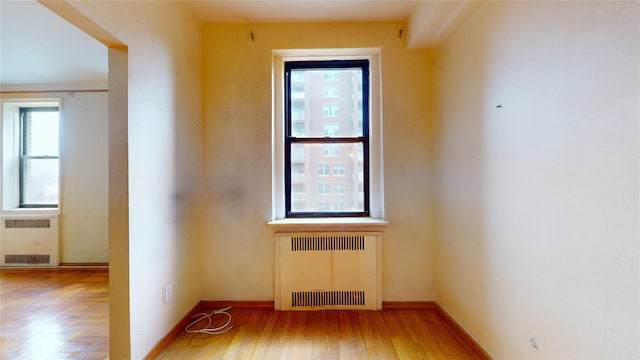 3250 Coney Island Ave Unit E15, Brooklyn, NY 11235 - unfurnished room with radiator heating unit, baseboards, and wood finished floors