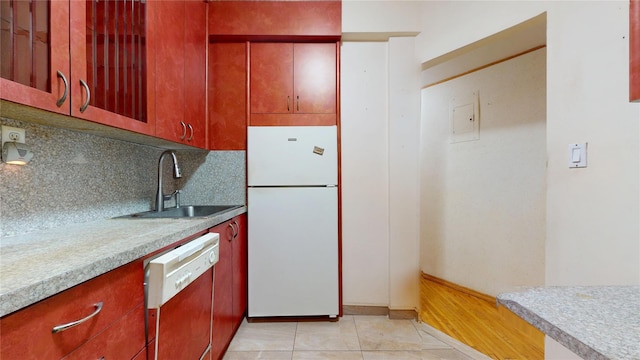 3250 Coney Island Ave Unit E15, Brooklyn, NY 11235 - kitchen featuring freestanding refrigerator, dishwashing machine, a sink, decorative backsplash, and light countertops