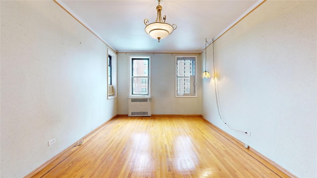 3250 Coney Island Ave Unit E15, Brooklyn, NY 11235 - unfurnished room with radiator, light wood-style floors, crown molding, and baseboards