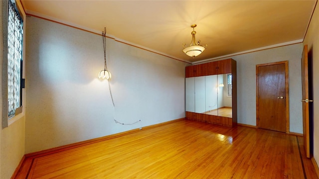 3250 Coney Island Ave Unit E15, Brooklyn, NY 11235 - unfurnished bedroom with crown molding, light wood-style floors, and baseboards