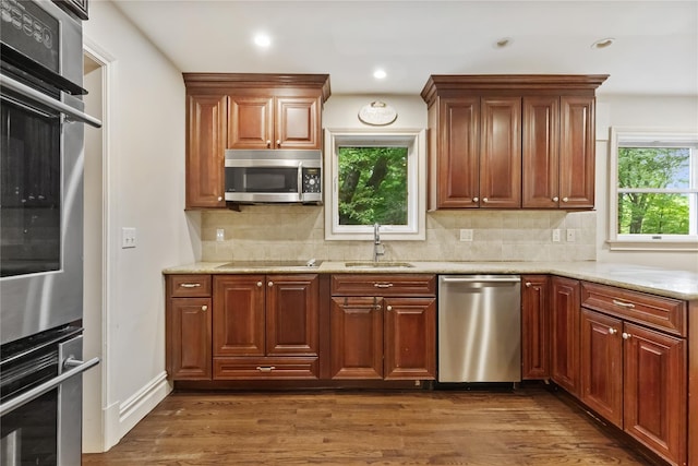 96 Warren St, Somers, NY 10589 - kitchen with appliances with stainless steel finishes, a sink, dark wood finished floors, light stone countertops, and recessed lighting