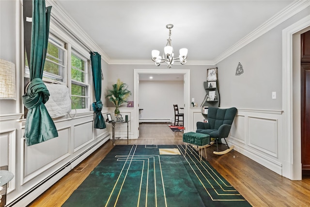 96 Warren St, Somers, NY 10589 - living area with a baseboard heating unit, a chandelier, wood finished floors, crown molding, and baseboard heating