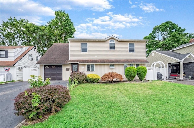 34 Marksman Ln, Levittown, NY 11756 - traditional-style home featuring driveway, an attached garage, and a gate