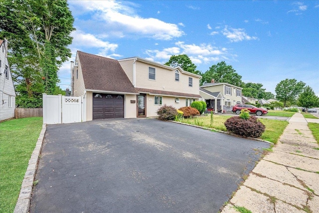 34 Marksman Ln, Levittown, NY 11756 - traditional-style home with asphalt driveway and an attached garage