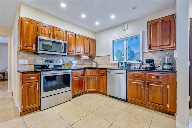 34 Marksman Ln, Levittown, NY 11756 - kitchen featuring stainless steel appliances, dark countertops, brown cabinets, backsplash, and recessed lighting