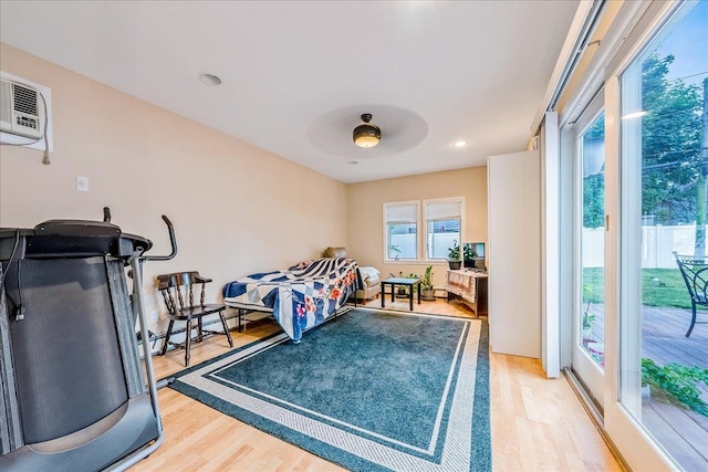 34 Marksman Ln, Levittown, NY 11756 - bedroom with light wood-style flooring, a baseboard heating unit, access to outside, a ceiling fan, and an AC wall unit