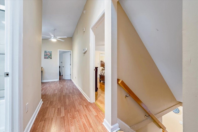 34 Marksman Ln, Levittown, NY 11756 - corridor featuring an upstairs landing, light wood-type flooring, and baseboards