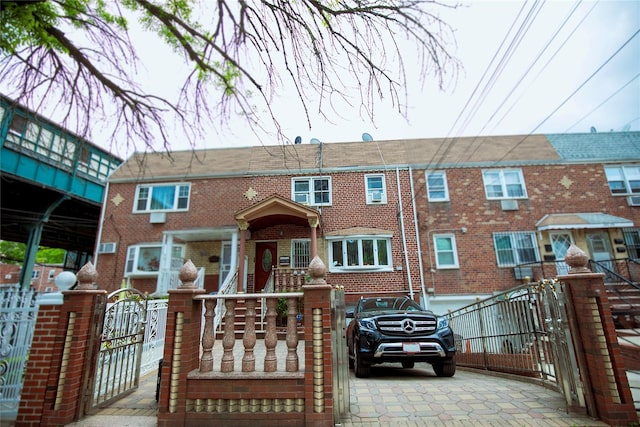 10124 78th St, Ozone Park, NY 11416 - multi unit property with a gate, brick siding, and a fenced front yard
